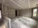 Partially constructed living room with drywall, visible window, and doorway at 83 W Emily Gardens Dr, Selma, NC 27576