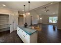 Kitchen with an island and pendant lights, open to the living room, and featuring modern appliances and countertops at 87 Tee Dr, Selma, NC 27576