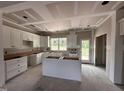 Unfinished kitchen with white cabinetry and an island at 87 Tee Dr, Selma, NC 27576