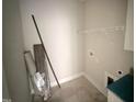 The laundry room area in a new home with tile floor and hook-ups at 87 Tee Dr, Selma, NC 27576