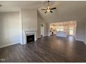 Open-concept living room featuring a fireplace with stone trim and hardwood floors at 87 Tee Dr, Selma, NC 27576