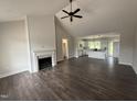 Spacious living room with a fireplace, vaulted ceiling, and hardwood floors at 87 Tee Dr, Selma, NC 27576
