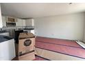 Eat-in kitchen with all white cabinets, granite countertops, and stainless steel appliances at 89 W Emily Gardens Dr, Selma, NC 27576
