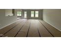 Spacious living room area, flooded with natural light from multiple windows and access to backyard at 89 W Emily Gardens Dr, Selma, NC 27576