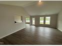 Bright living room boasting vaulted ceilings, wood-look flooring, and ample natural light at 89 W Emily Gardens Dr, Selma, NC 27576