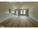 Bright living room with large windows offering plenty of natural light and an open layout at 89 W Emily Gardens Dr, Selma, NC 27576