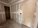 Partially complete entryway featuring drywall, a side-light window, and access to an adjacent room at 9 W Emily Gardens Dr, Selma, NC 27576
