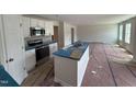 Modern kitchen featuring stainless steel appliances, an island with sink, and ample counter space at 9 W Emily Gardens Dr, Selma, NC 27576