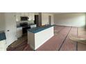 Kitchen featuring white cabinets, stainless steel appliances, and a center island with a sink at 9 W Emily Gardens Dr, Selma, NC 27576