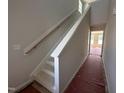 A newly constructed staircase with white risers and stringers, and a wood handrail against a neutral wall at 9 W Emily Gardens Dr, Selma, NC 27576