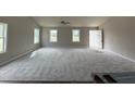 Bright, open-concept living room with plush carpeting and plenty of natural light at 91 Harvest Hills Ln, Dunn, NC 28334