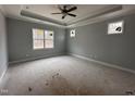 Spacious bedroom with tray ceiling, ample natural light from large windows, and neutral color palette at 98 Laramie Ln, Selma, NC 27576