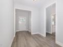Inviting entryway with light gray walls and stylish gray wood-look flooring at 98 Laramie Ln, Selma, NC 27576