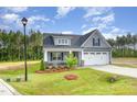 Landscaped one-story home boasting a two-car garage and a beautifully maintained lawn at 98 Laramie Ln, Selma, NC 27576