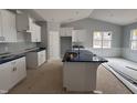 Bright kitchen featuring custom cabinets, an island with counter seating, and granite countertops at 98 Laramie Ln, Selma, NC 27576