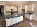 Well-lit kitchen featuring a large island with modern appliances and ample cabinet space at 98 Laramie Ln, Selma, NC 27576