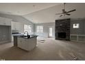 Open concept kitchen with an island, custom cabinets, and granite countertops next to the living area at 98 Laramie Ln, Selma, NC 27576