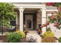 Charming front porch with stone accents, decorative plants, and a cozy seating area at 1005 Vesper Ct, Durham, NC 27703