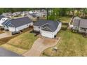 This aerial showcases the home, driveway, and its placement within a friendly neighborhood at 105 Jasper Creek Ct, Wilson's Mills, NC 27520