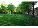Expansive green space with mature trees offers a serene and park-like setting at 108 W Savannah Ridge Rd, Holly Springs, NC 27540