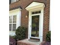 Elegant front door with glass panes and sidelights, framed by manicured greenery at 108 W Savannah Ridge Rd, Holly Springs, NC 27540