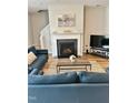 Bright living room with a fireplace, a TV, and comfortable seating arrangement perfect for relaxing at 1129 Kudzu St, Durham, NC 27713