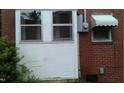 An exterior view showing the side of the home, with a wall and windows at 1210 Cypress St, Rocky Mount, NC 27801