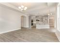 Open-concept living room showcasing hardwood floors, recessed lighting, and an archway to the kitchen at 1217 Linkwood Way, Fuquay Varina, NC 27526