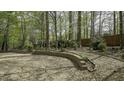 Gravel backyard featuring tiered retaining walls with garden beds perfect for serene outdoor enjoyment at 1505 Starmont Dr, Hillsborough, NC 27278