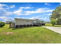 Quaint single-story house enhanced by a spacious green lawn, accompanied by a concrete driveway and a pleasant porch at 162 E Abbey Ct, Smithfield, NC 27577