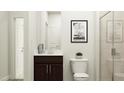 Bright bathroom with a modern vanity, framed art, and glass enclosed shower at 189 Tennyson Dr # 236, Garner, NC 27529