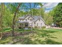 Attractive two-story brick home with a covered front porch and well-maintained landscaping at 1900 High Oaks Ln, Raleigh, NC 27606