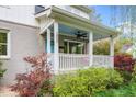 Inviting front porch with a porch swing, ceiling fan, and a blue-painted ceiling for relaxing at 200 Lincoln Ct, Raleigh, NC 27610