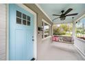 Charming front porch featuring a swing, ceiling fan, and a bright blue door creating a welcoming entrance at 200 Lincoln Ct, Raleigh, NC 27610