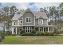 Attractive two-story home with a welcoming front porch and manicured landscaping at 2408 Merion Creek Dr, Apex, NC 27539