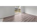 Living space featuring luxury vinyl plank flooring and sliding glass doors to the outside at 308 Arch Canyon Cir, Zebulon, NC 27597