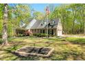 Beautiful brick home with an American flag and a manicured lawn surrounded by trees at 363 Dublin Dr, Sanford, NC 27330