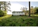 Picture of the back of the house and the spacious backyard with plenty of nature around it at 3728 Gideon Dr, Wake Forest, NC 27587