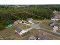 An aerial view of homes highlighting the large lot nestled amongst mature trees at 40 Patricia S Vann Ct, Dunn, NC 28334