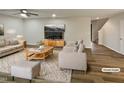 Comfortable living room featuring a ceiling fan, plush seating, a modern TV setup, and warm, inviting lighting at 400 Collington Dr, Mebane, NC 27302