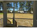 View of the expansive backyard from the screened porch, offering a serene outdoor living space at 420 Shelby Meadow Ln, Angier, NC 27501