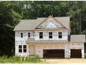 New construction home featuring a two-car garage and classic architectural details. Ready for final finishing at 420 Shelby Meadow Ln, Angier, NC 27501