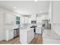 Bright, spacious kitchen with white cabinetry, stainless steel appliances, and a center island at 420 Shelby Meadow Ln, Angier, NC 27501