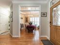 Inviting foyer showcasing a dining room with hardwood floors, shutters, and a chandelier, viewed from the front entrance at 4203 Norman Ridge Ln, Raleigh, NC 27613