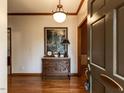 Inviting foyer features hardwood floors, an ornate chest, and a decorative light fixture at 422 Old Scarborough Ln, Garner, NC 27529