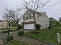 Charming two-story home featuring a well-manicured front yard and a two-car garage at 4610 Miller Dr, Durham, NC 27704