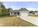 Beautiful house with a covered porch, a two-car garage and a landscaped front yard at 52 Sagebrook Ct, Zebulon, NC 27597