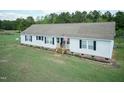 An elevated view shows a well-maintained ranch home with a spacious yard and mature trees at 660 Our Way, Linden, NC 28356