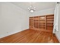 Spacious living room featuring hardwood floors, custom shelving, and recessed lighting at 7002 Old Trail Dr, Durham, NC 27712