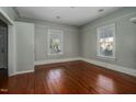 Bedroom featuring hardwood floors, neutral paint, and large windows providing natural light at 703 Cokey Rd, Rocky Mount, NC 27801